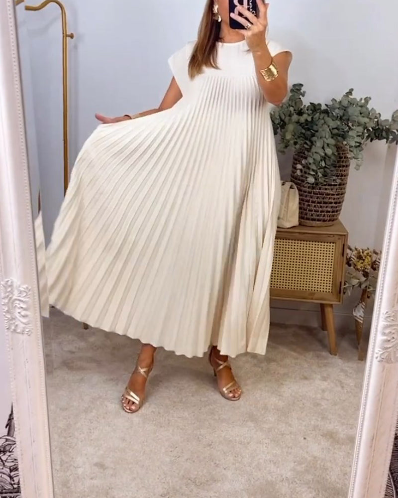 Long cocktail dress with soft pleats photographed on a female model.