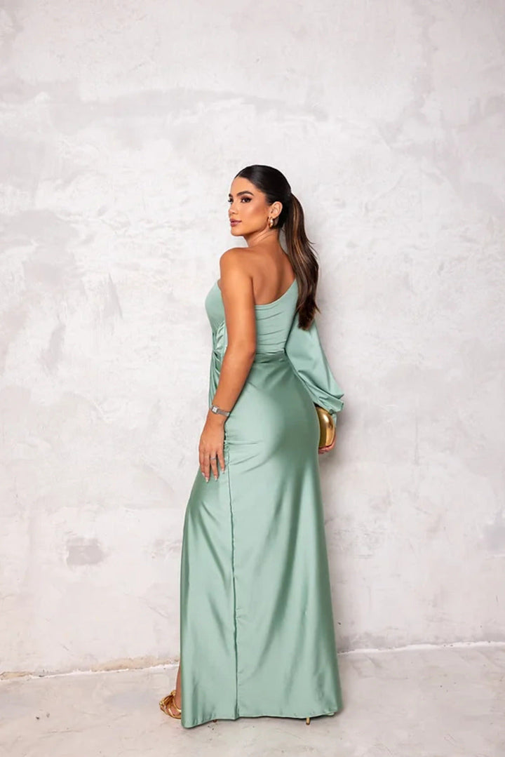 Woman wearing a graceful sleeveless maxi dress on a clean background.