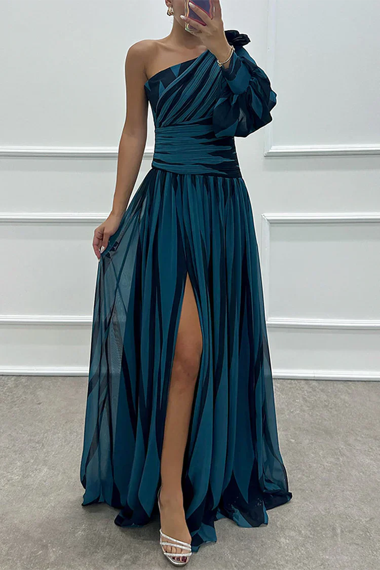 Model posing in a modern one-shoulder striped dress on a clean background.
