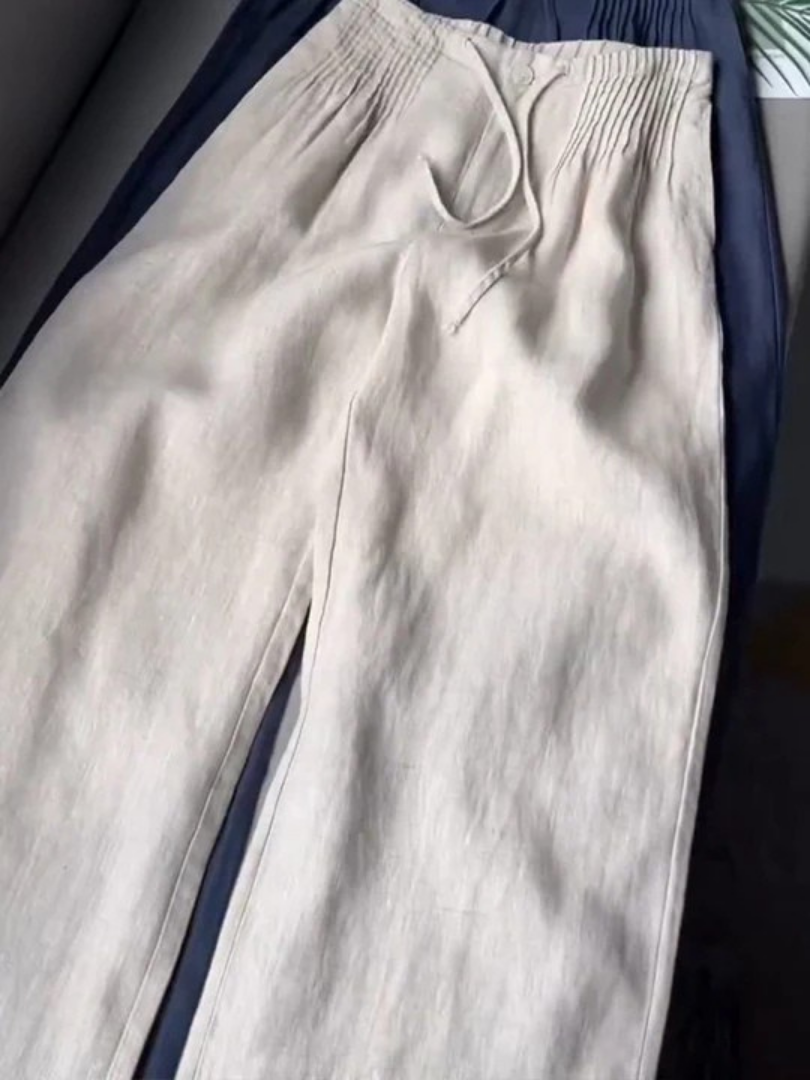 Wide-leg pants styled for everyday wear against a plain background.