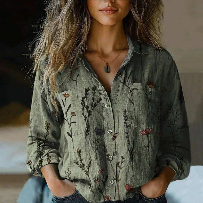 Lightweight printed blouse with a loose draped silhouette on a clean background.