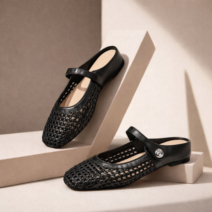 Female model wearing easy step woven flats with a clean outfit on a plain background.