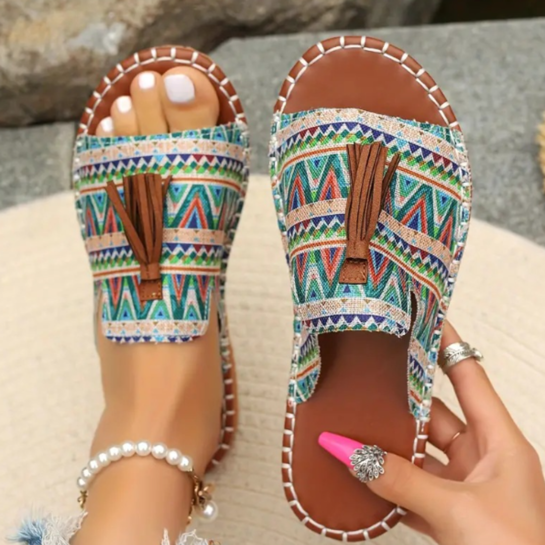 Slip-on summer sandals in bright tones shown on a plain background.