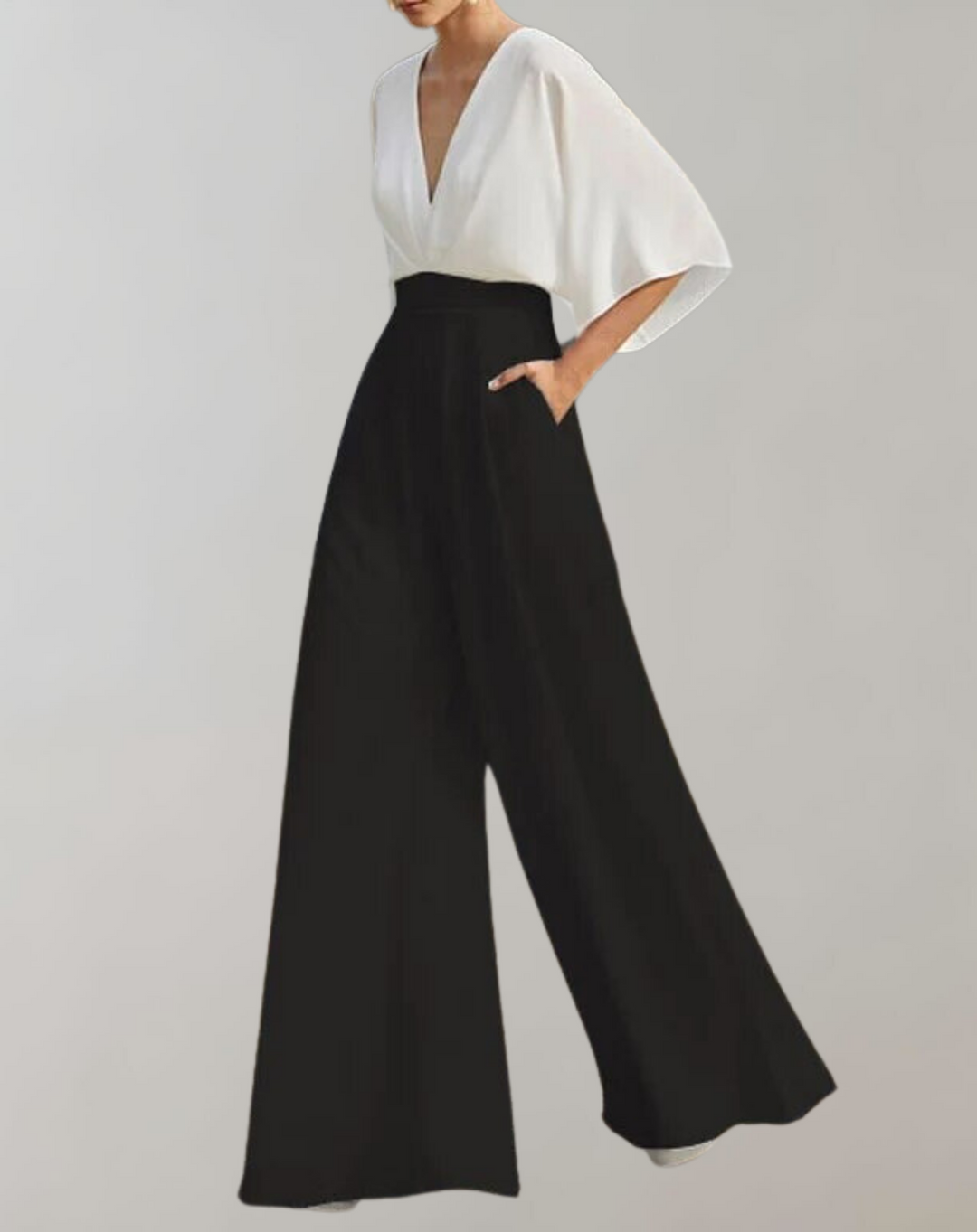 Female model wearing a dramatic wide-leg jumpsuit with elegant movement.