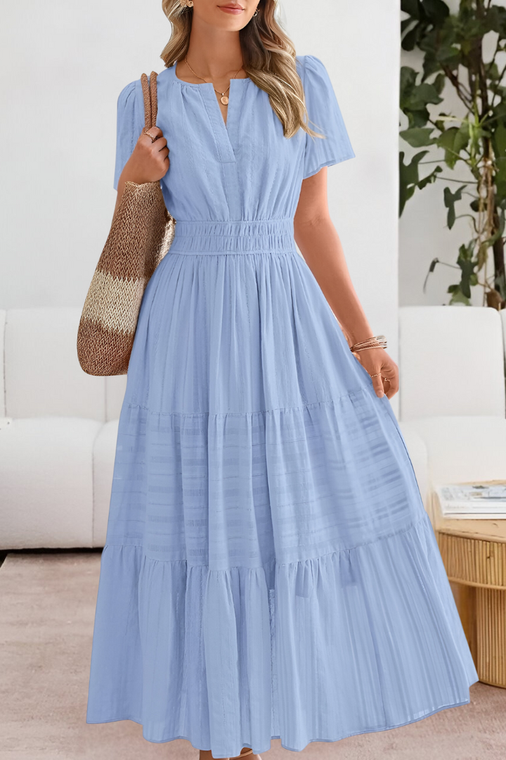 Stylish summer maxi dress with loose fit and soft fabric look on a plain background.