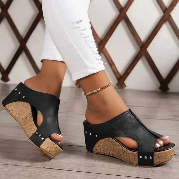 Feet shown only wearing adjustable strap orthopedic sandals on a plain background.