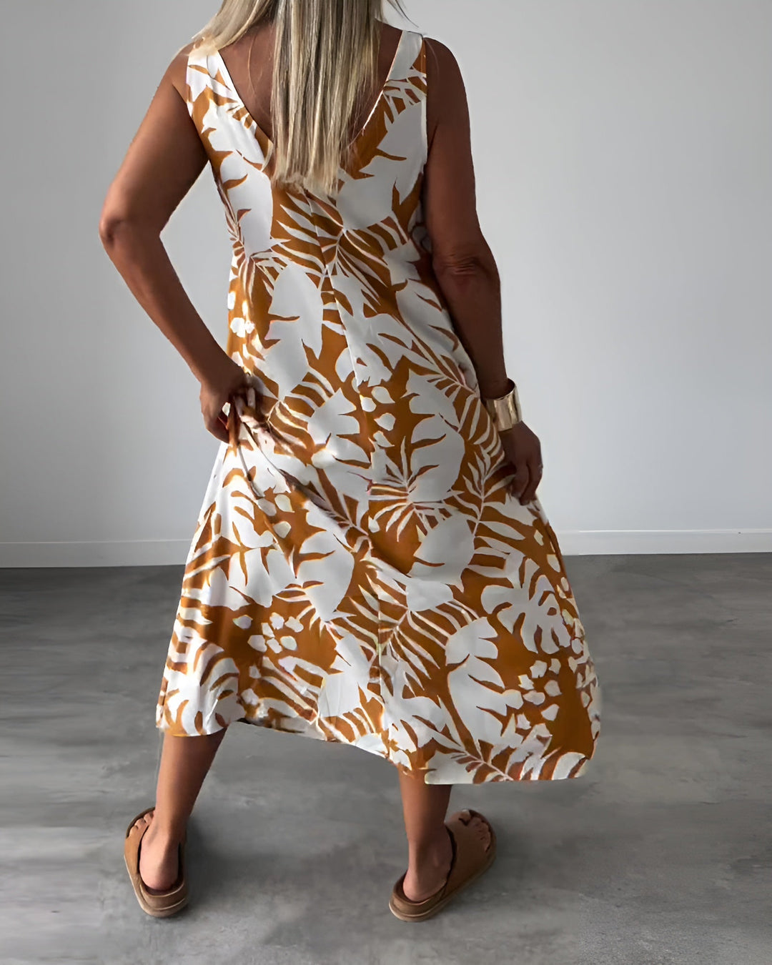 Flattering maxi dress designed with an open neckline and smooth flowing, back angle view 