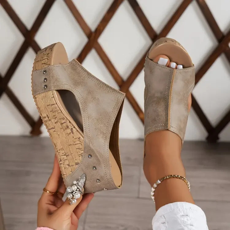 Feet in orthopedic sandals with contoured footbed on a clean background.