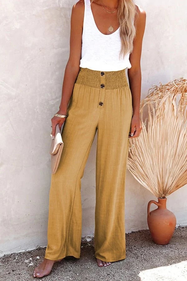Woman wearing breathable high-waisted trousers with an elegant drape.