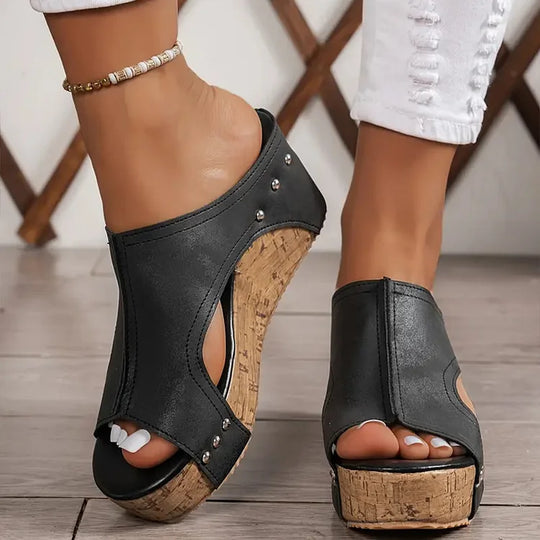 Close-up of feet in supportive cushioned sandals on a clean background.