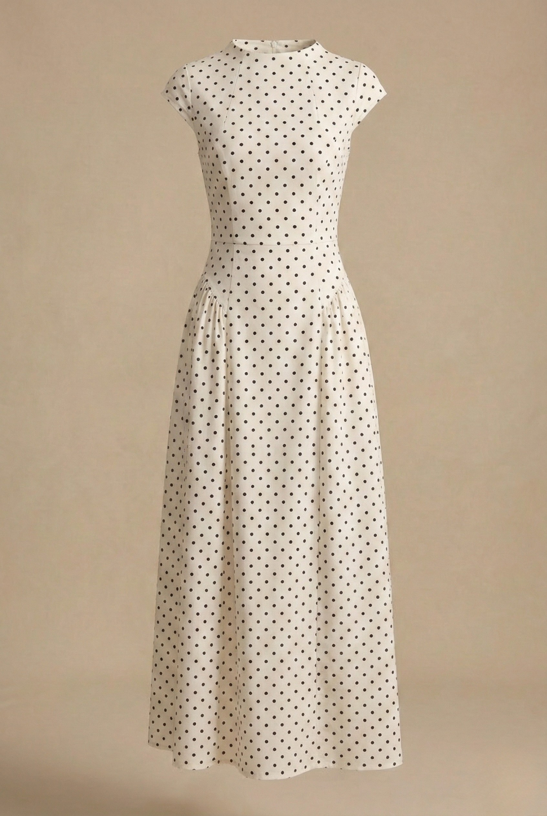 A round neck maxi dress with a fitted waist and graceful drape against a plain background.
