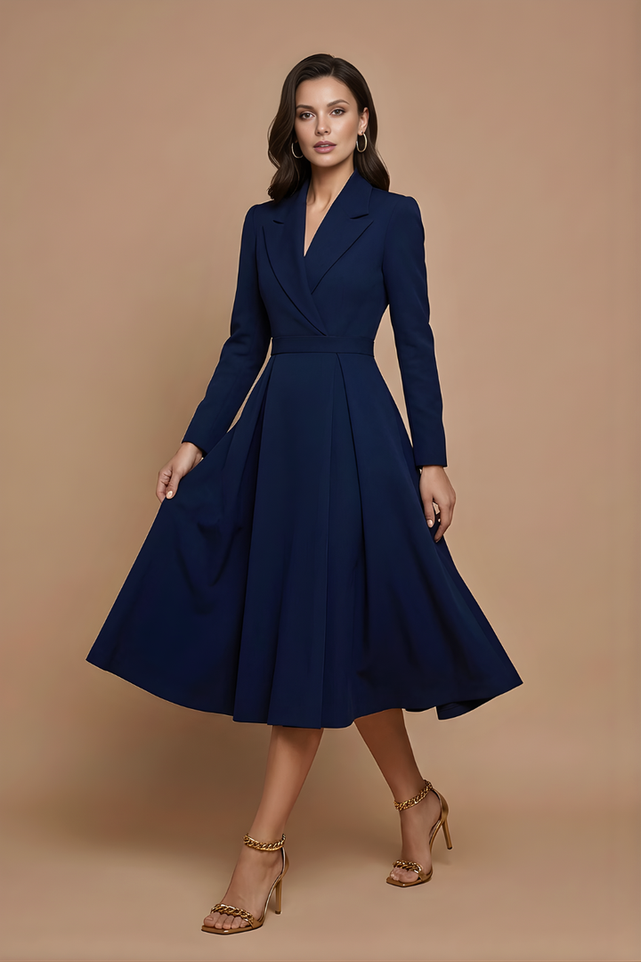 Woman wearing an elegant midi dress with a notched collar and pleated design on a plain background.
