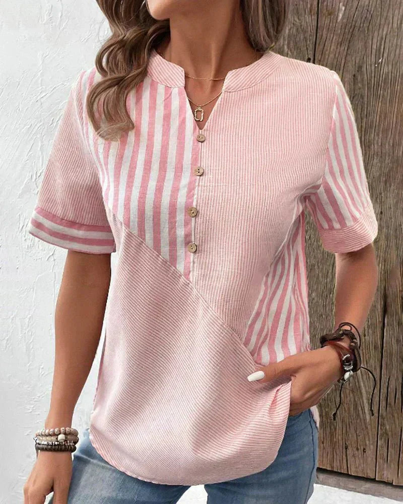 Striped women’s blouse shown with a wearer against a plain background.