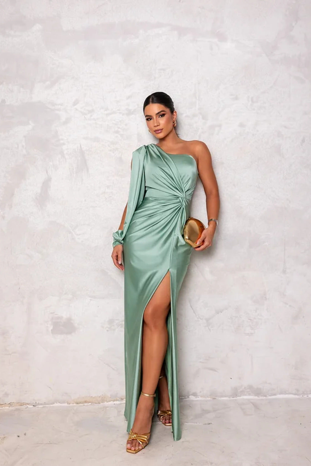Female model posing in a lightweight maxi dress with a plain backdrop.