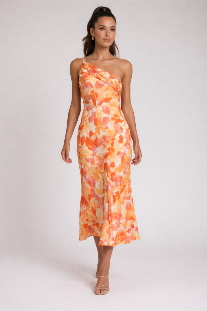 Female model in a floral one-shoulder dress on a plain background.