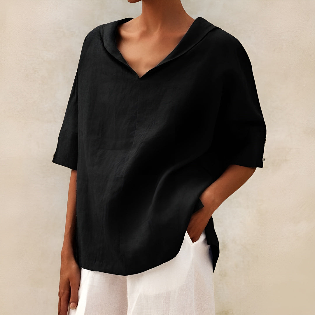 Women’s soft blouse shown on a plain background with easy movement and refined casual design.