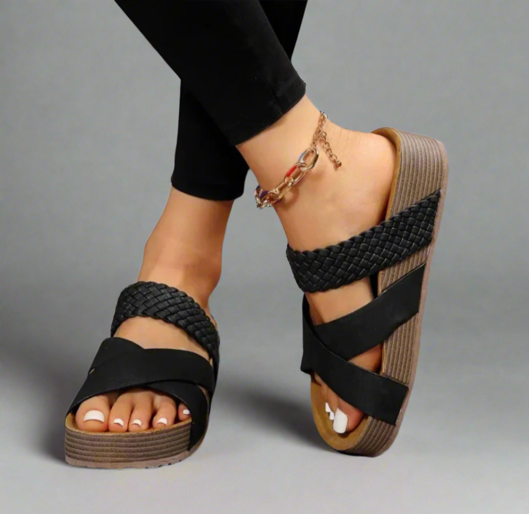 Foot shown in supportive sandal with cushioned design.