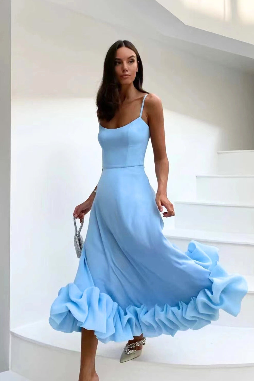 Woman in a graceful draped dress on a clean background.