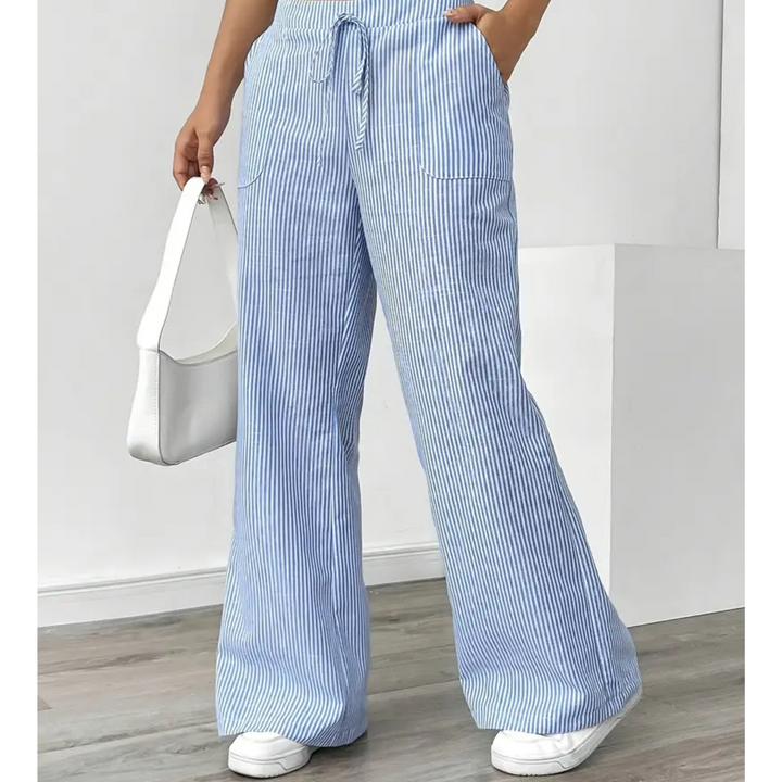 Vertical striped pants for women with pockets on a simple background.