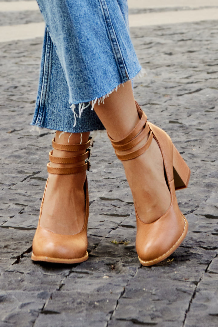 Close-up of a foot wearing a comfortable ankle strap heel sandal.