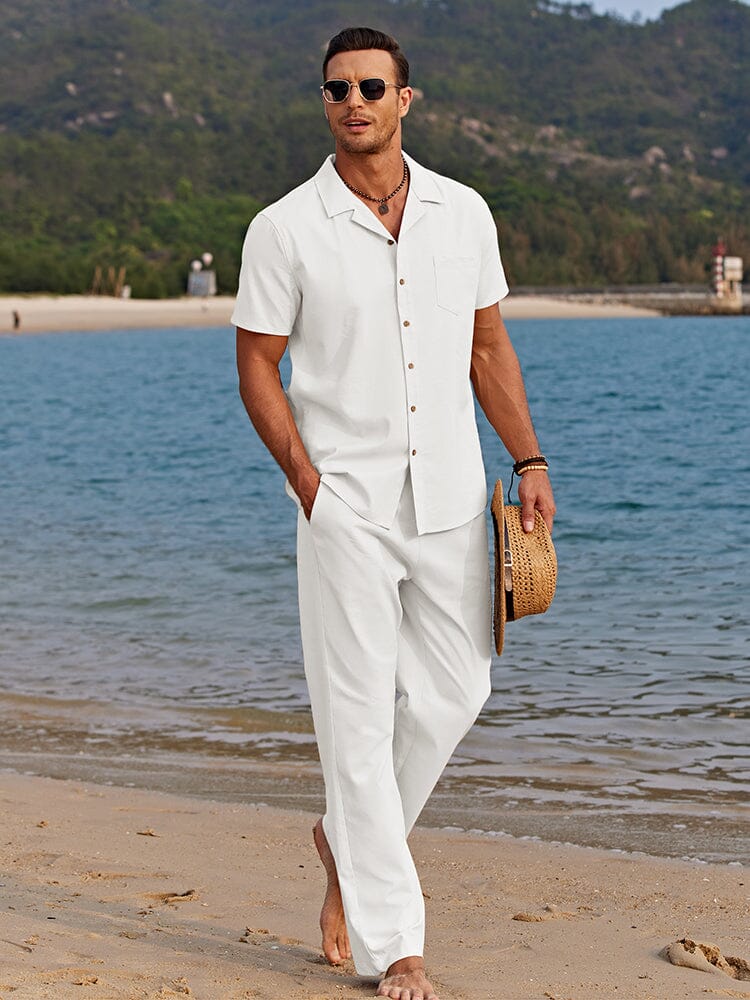 Male model wearing a two-piece shirt and pants set on a plain background.