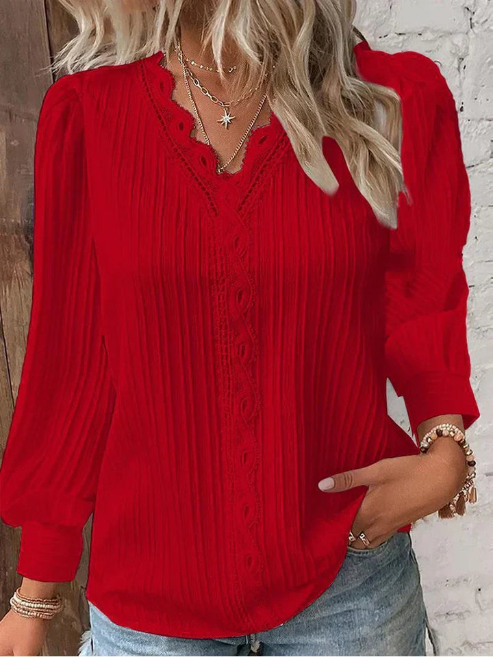 Airy chiffon blouse with refined lace trim shown against a clean background.