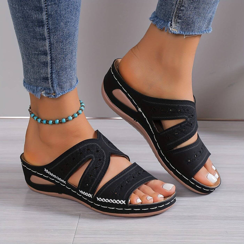 Model showing lightweight support sandals on a plain background.
