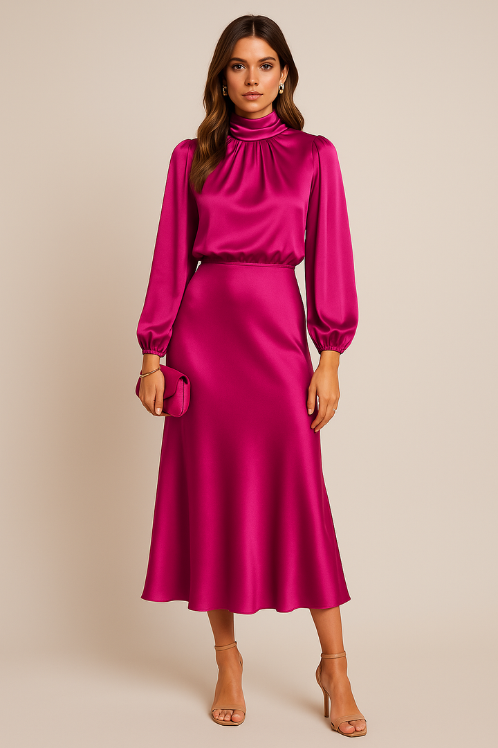 Female modeling a stylish midi outfit against a plain backdrop.