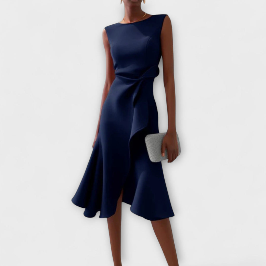 Female model showcasing a sleeveless evening midi dress against a plain background.