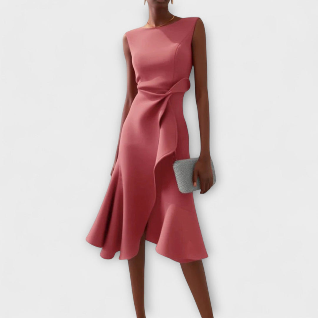 Woman wearing a chic asymmetrical dress with soft flowing movement.
