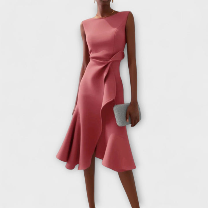Woman wearing a chic asymmetrical dress with soft flowing movement.