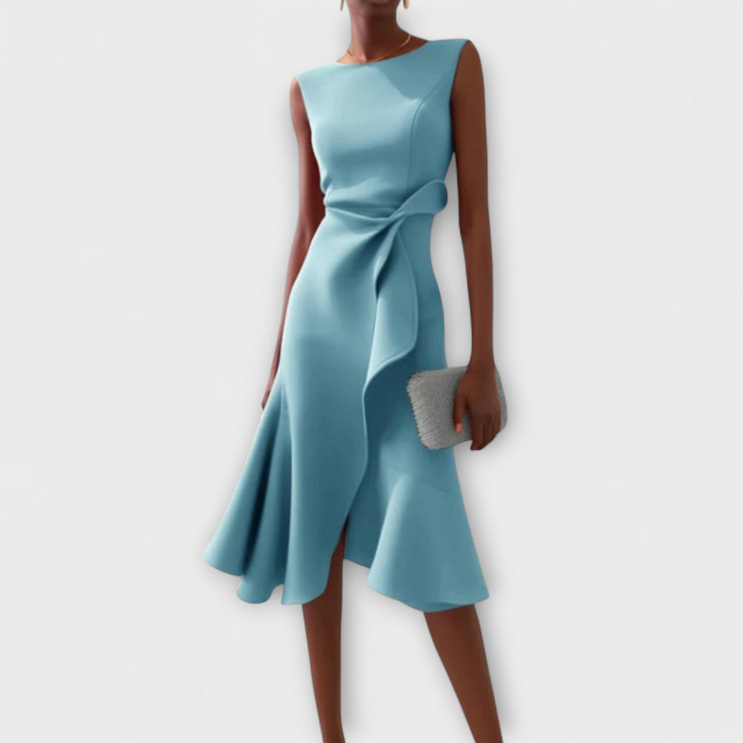 Female standing in a sleeveless midi dress designed for evening occasions.