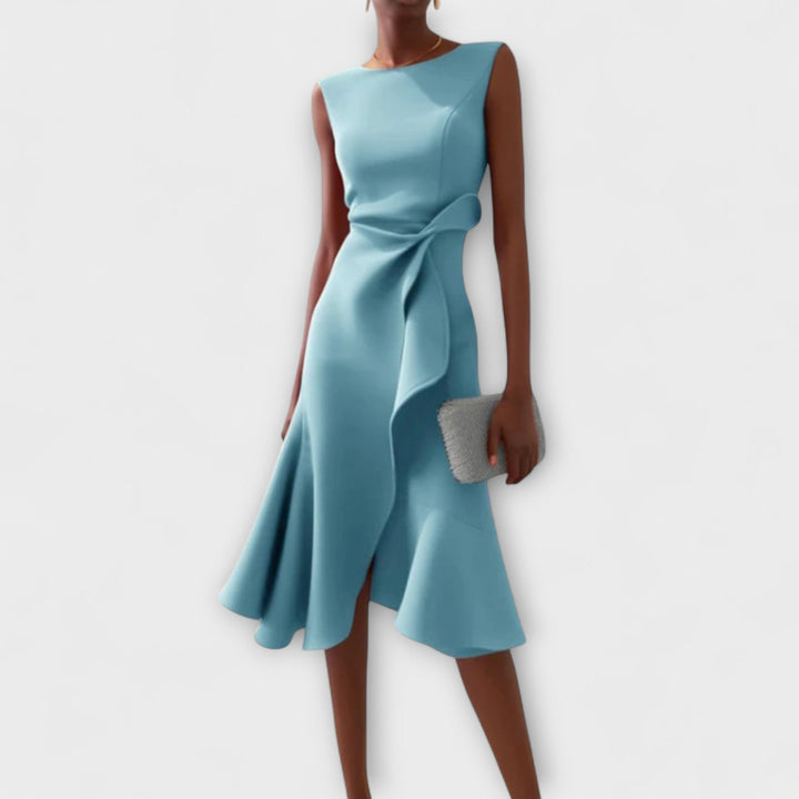 Female standing in a sleeveless midi dress designed for evening occasions.