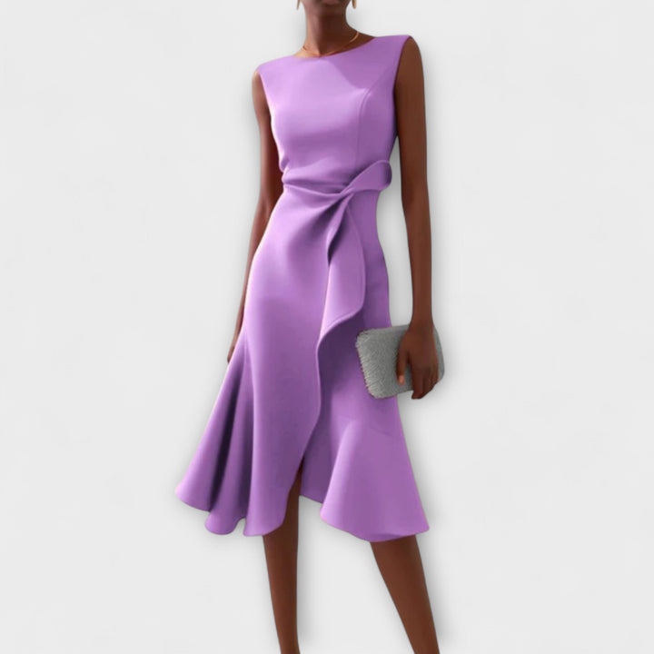 Woman in an elegant draped dress with a flattering midi silhouette.