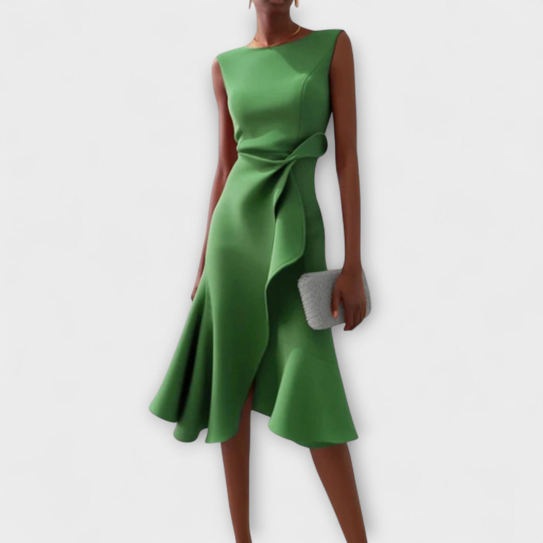Female model wearing a stylish sleeveless party dress on a plain backgroun