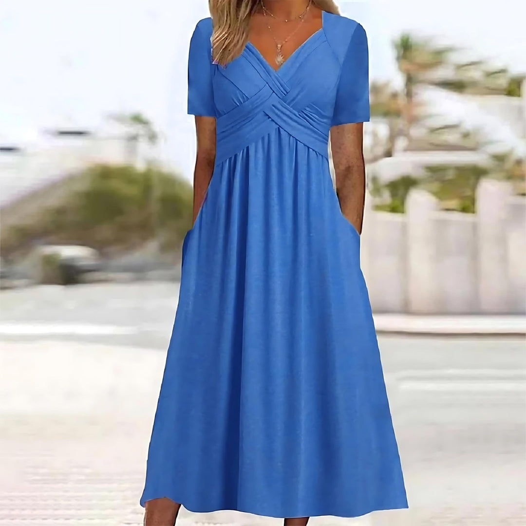 Woman in a casual dress with A-line shape on a plain background.