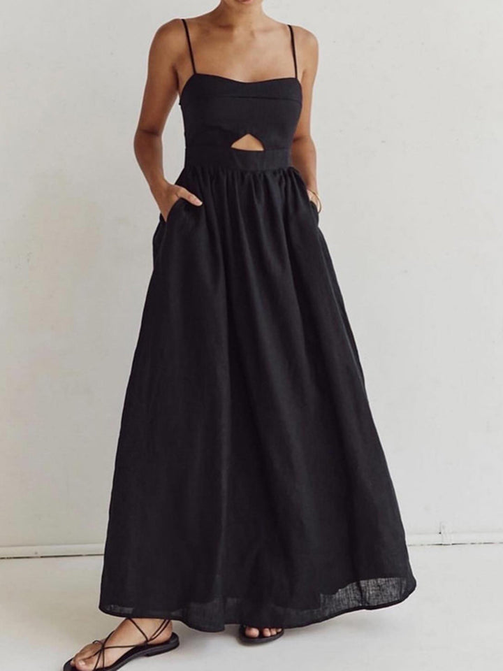Female model in a long sleeveless dress featuring a heart-shaped neckline on a plain background.
