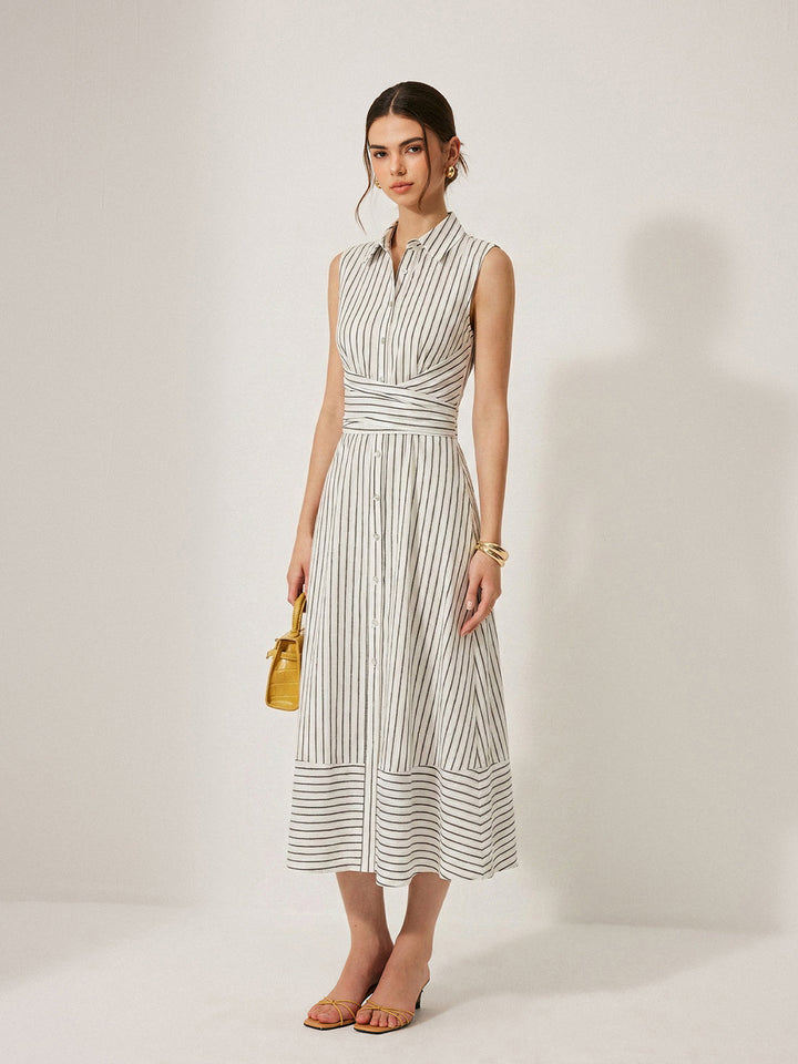 Female wearing a sleeveless midi dress with a collared neckline against a plain background.