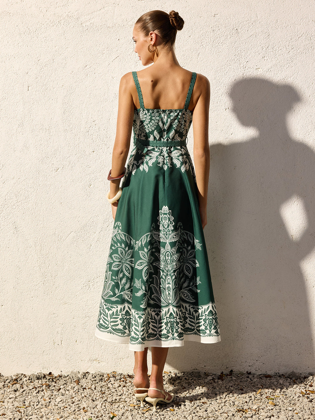 Model wearing a flowing maxi dress with a simple square neck design.