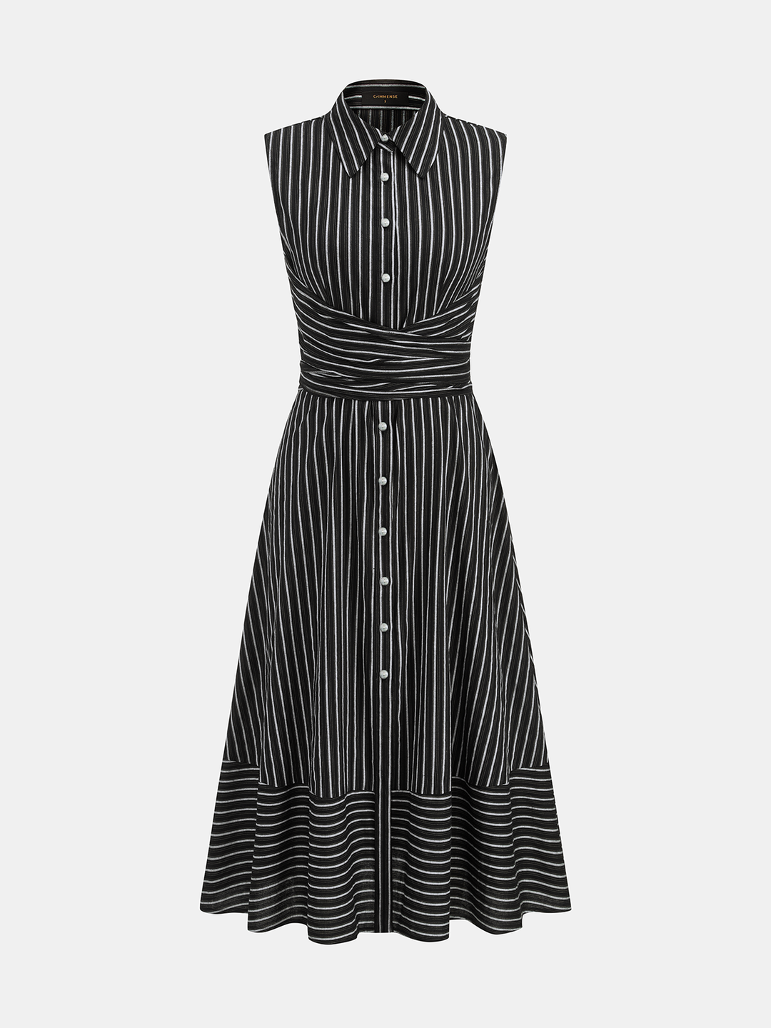 Woman standing in a sleeveless midi dress featuring a streamlined silhouette on a plain background.
