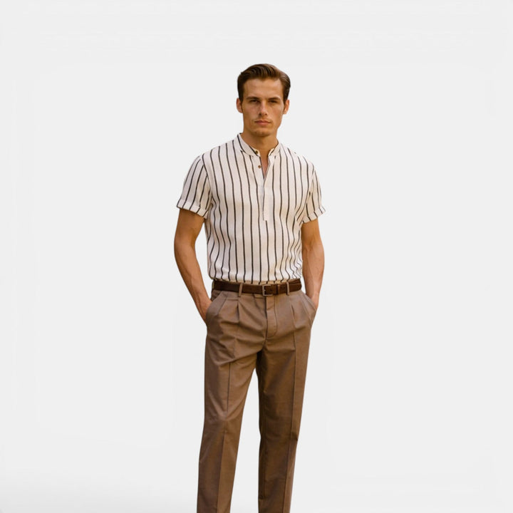  Male model wearing a short sleeve linen shirt in front of a plain back