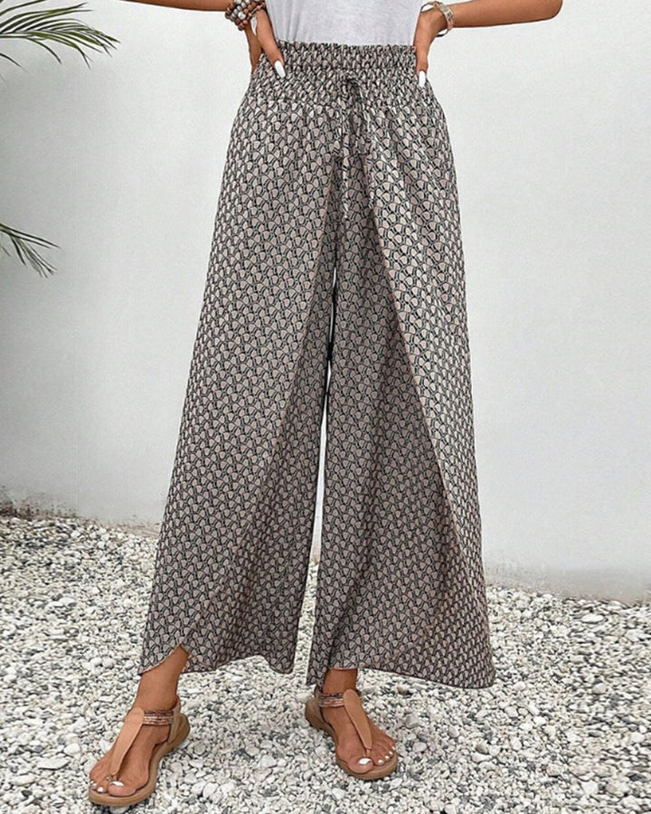 Flowing fit trousers displayed without a model on a plain background.