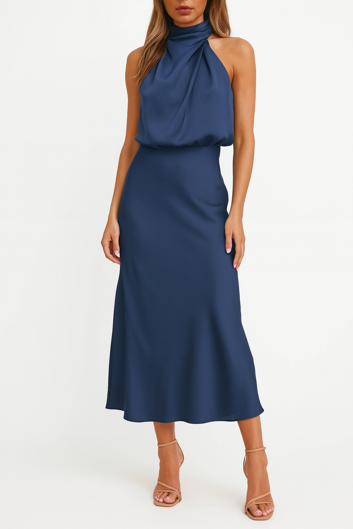 Female standing in a lightweight off-shoulder dress with a midi length silhouette.