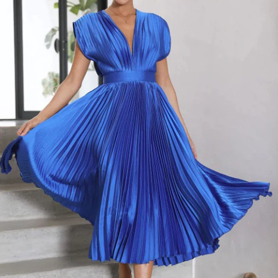 Woman presenting a classy dress against a clean background.