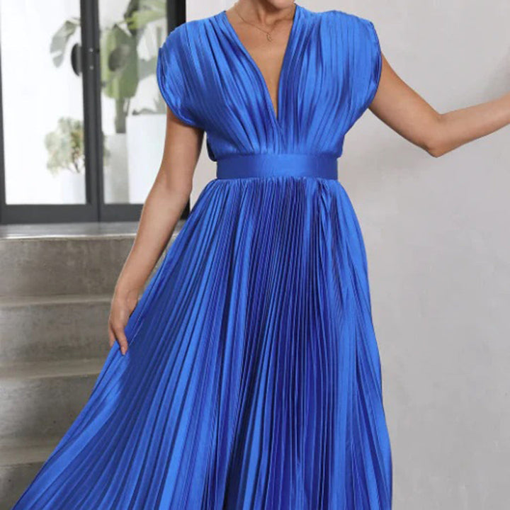 Female model showcasing a stylish dress on a clean background.