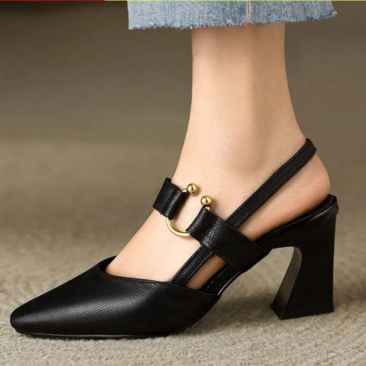 Female model wearing elegant comfort heels on a plain background.
