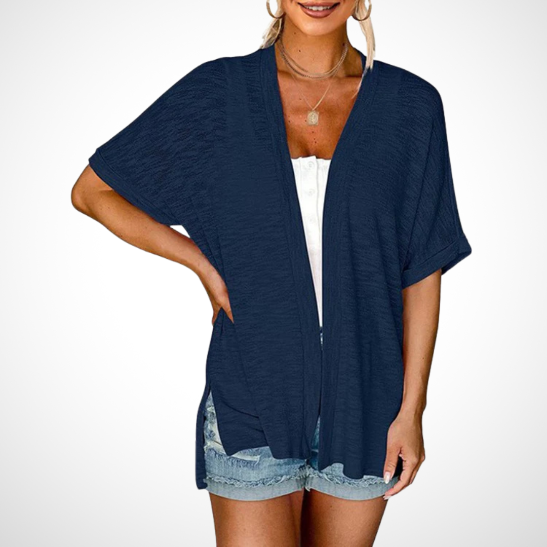 Short sleeve draped cardigan styled simply on a clean background.