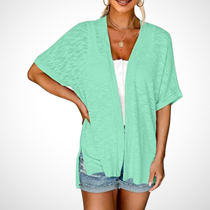 Minimalist open-front cardigan with relaxed silhouette on plain background.