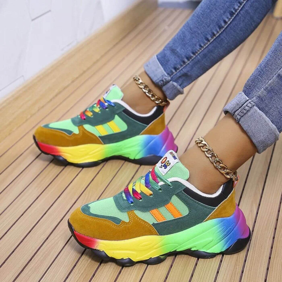 Woman wearing breathable casual sneakers while standing on a plain background.