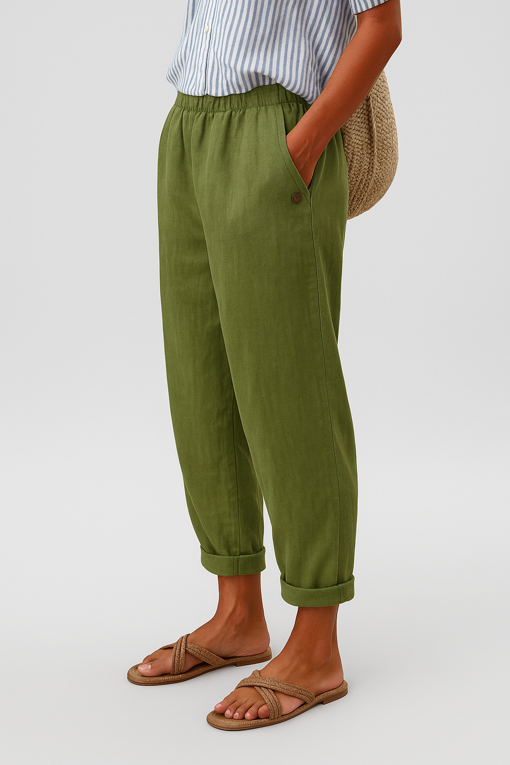 Woman modeling elegant side-pocket pants on a clean background.